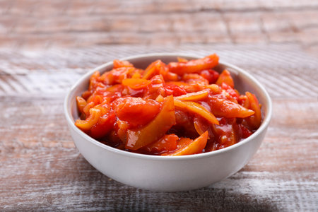 Bowl of delicious lecho on wooden table, closeupの写真素材