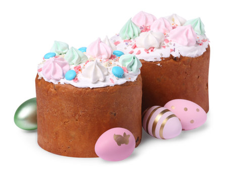 Traditional Easter cakes with meringues and painted eggs isolated on white