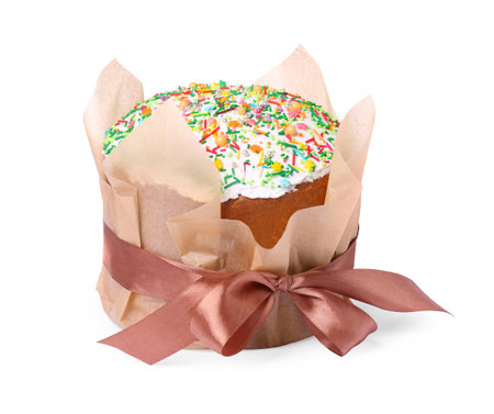 Traditional Easter cake with sprinkles wrapped in parchment paper with ribbon isolated on white