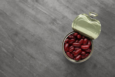 Tin can of canned red kidney beans on gray table, top view. Space for textの写真素材