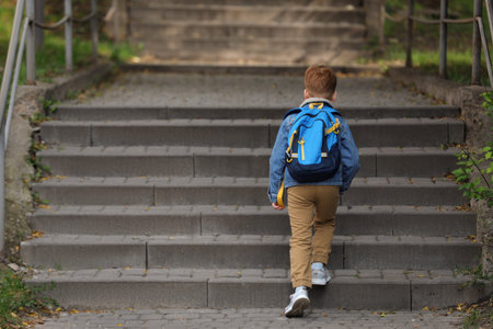 Little boy with backpack going to school, back viewの写真素材