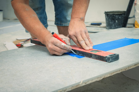Worker making socket hole in tile indoors, closeupの写真素材