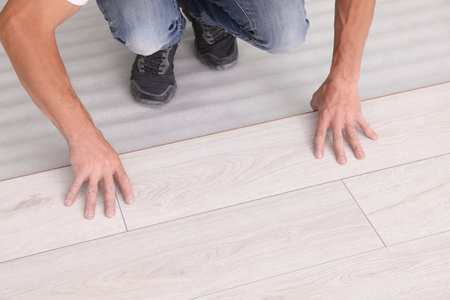 Man installing new laminate flooring, closeup viewの写真素材