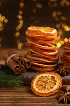 Dry orange slices, anise stars and cinnamon sticks on wooden table. bokeh effectの写真素材
