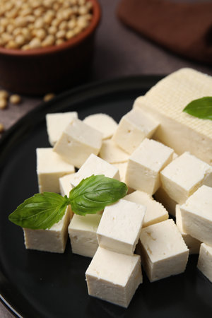 Delicious tofu cheese, basil and soybeans on brown table, closeupの写真素材