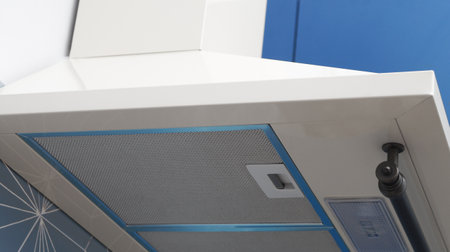 Modern electric exhaust hood in kitchen, closeup