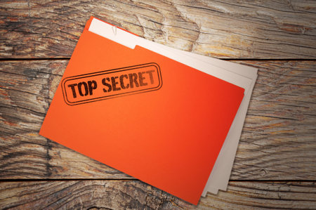 Orange file with documents and Top Secret stamp on wooden table, top view