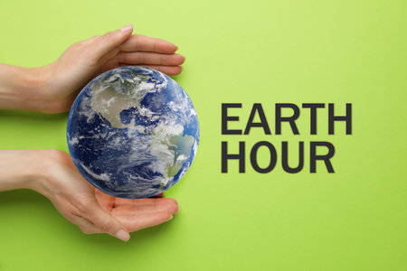 Take care of Earth, turn off lights for hour. Woman with globe illustration on light green background, top viewの写真素材