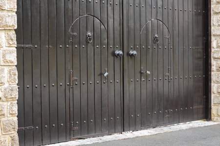 View of beautiful arched wooden doors outdoors