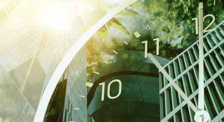 Time related concepts. Multiple exposure of clock, office buildings and treesの写真素材