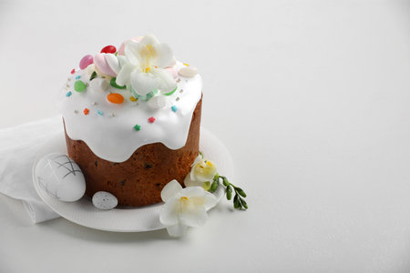 Traditional Easter cake with sprinkles, jelly beans, marshmallows, flowers and decorated eggs on...
