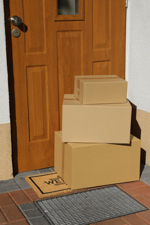 Parcels delivered on mat near front doorの写真素材