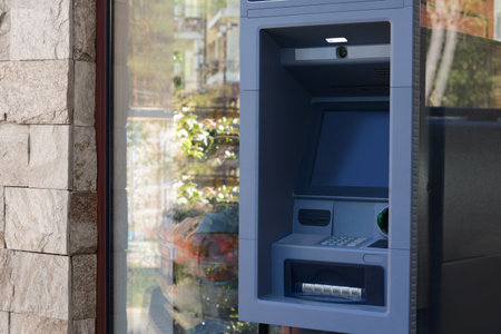 Automated teller machine outdoors on sunny day. Space for text