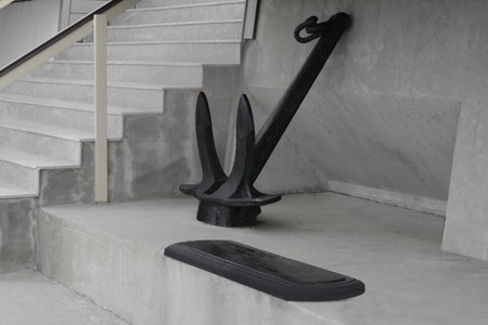 Huge and massive anchor near building outdoors