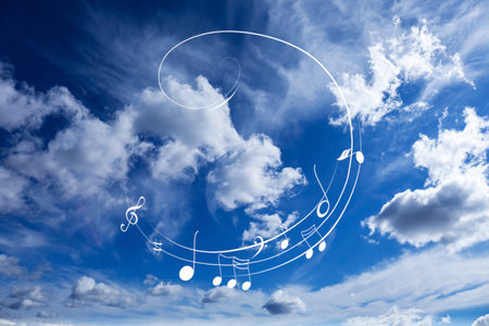 Treble clef and swirly staff with musical notes against skyの写真素材