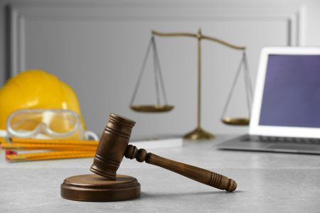 Construction and land law concepts. Judge gavel, scales of justice, safety glasses, protective...