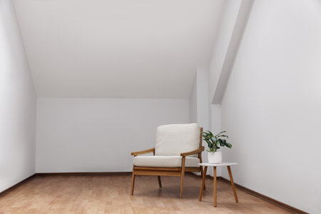 Attic spacious room interior with slanted ceiling and furnitureの写真素材
