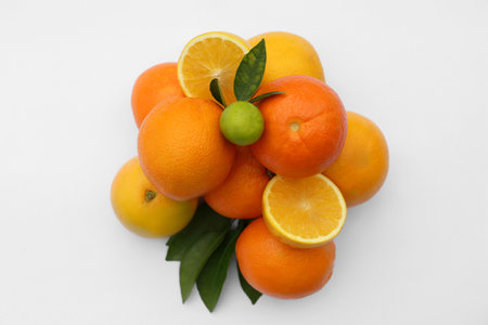 Different citrus fruits and leaves on white background, top viewの写真素材