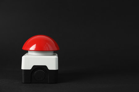 Red button of nuclear weapon on black background, space for text. War conceptの写真素材
