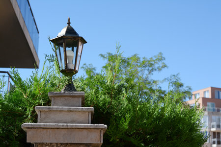 Pillar with vintage street lamp outdoors on sunny day, space for textの写真素材