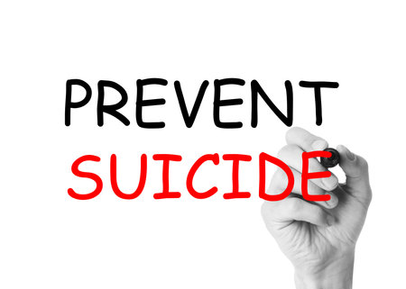 Man writing phrase Prevent Suicide on glass board against white background, closeup. Black and white photo with red color accentの写真素材