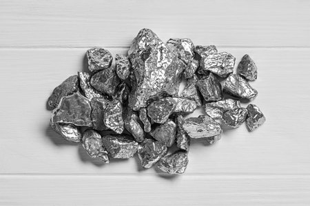 Pile of silver nuggets on white wooden table, top viewの写真素材