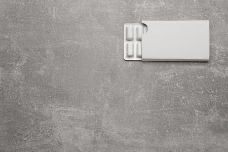 Blister with chewing gums on light gray table, top view. Space for textの写真素材