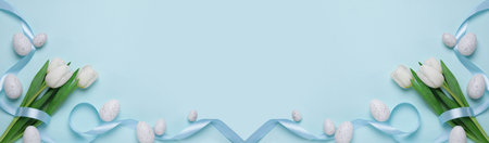 Flat lay composition with decorated Easter eggs and flowers on pale light blue background, space for text. banner designの写真素材