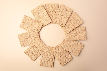 Fresh crunchy crispbreads on beige background, flat layの写真素材