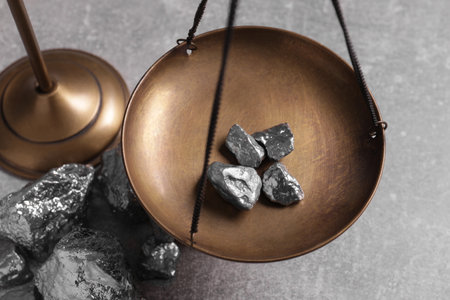 Vintage scales with silver nuggets on light gray table, above viewの写真素材