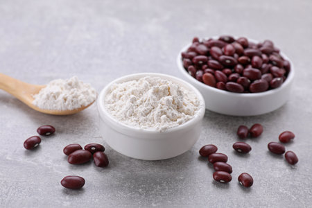 Kidney bean flour and seeds on light gray table
