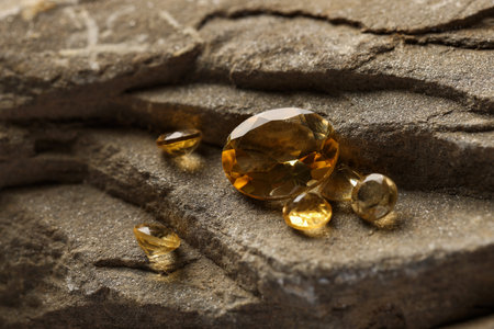 Beautiful yellow gemstones for jewelry on stone surface, closeupの写真素材