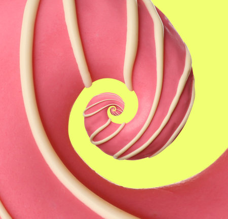 Twisted donut with strawberry icing and topping on light yellow background, spiral effectの写真素材