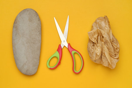 Rock, crumpled paper and scissors on orange background, flat layの写真素材
