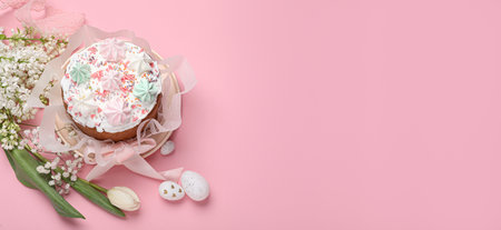 Traditional Easter cake with meringues and painted eggs on pink background, top view. Banner design...