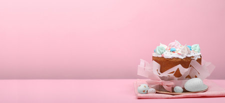 Traditional Easter cake with meringues and painted eggs on pink background, space for text. Banner...
