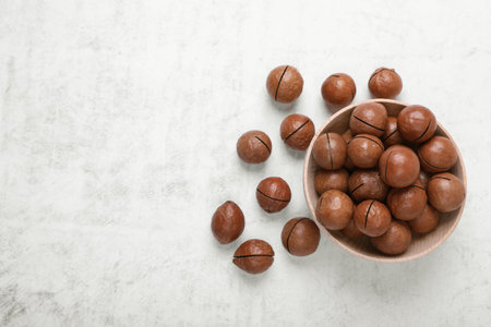 Delicious organic Macadamia nuts on light gray table, flat lay. Space for textの写真素材