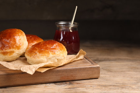 Tasty scones prepared on soda water and jam on wooden table, space for textの写真素材
