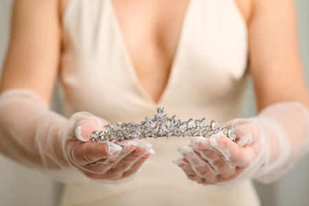 Bride holding luxurious tiara on gray background, closeup viewの写真素材
