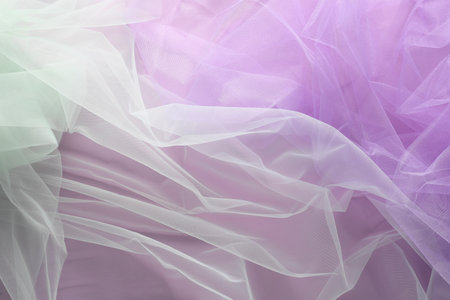 Beautiful tulle fabric on lilac background, flat layの写真素材