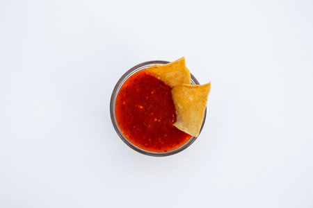 Tasty salsa sauce and tortilla chips on white background, top viewの写真素材