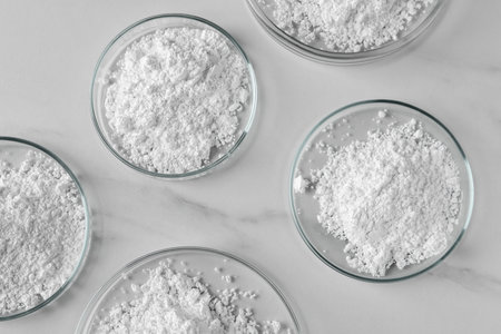 Many petri dishes with calcium carbonate powder on white marble table, flat layの写真素材