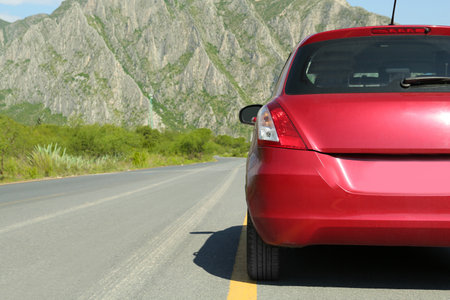 Beautiful view of mountains and car asphalt on highway outdoors, closeup. road tripの写真素材