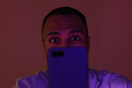Man using smartphone at night, closeup. Internet addictionの写真素材