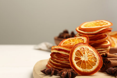 Dry orange slices., anise stars and cinnamon sticks on white table, closeup. Space for textの写真素材