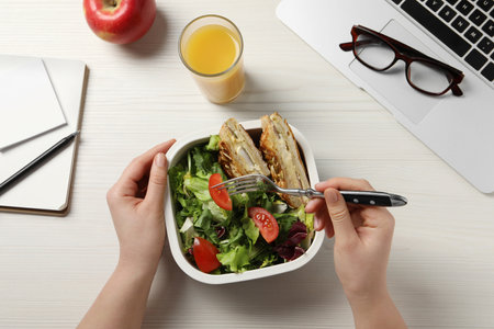 Office employee having business lunch at workplace, top viewの写真素材