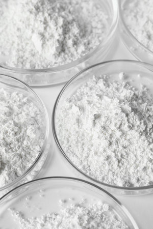 Petri dishes with calcium carbonate powder on white table, closeupの写真素材