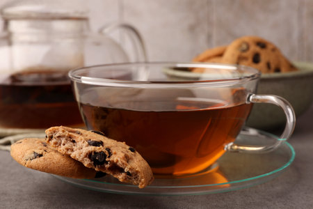 Cup of hot tea and chocolate chip cookies on gray table, closeupの写真素材