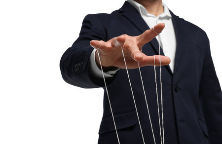 Man in suit pulling strings of puppet on white background, closeupの写真素材