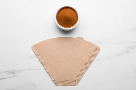 Paper filter and instant coffee on white marble table, flat layの写真素材
